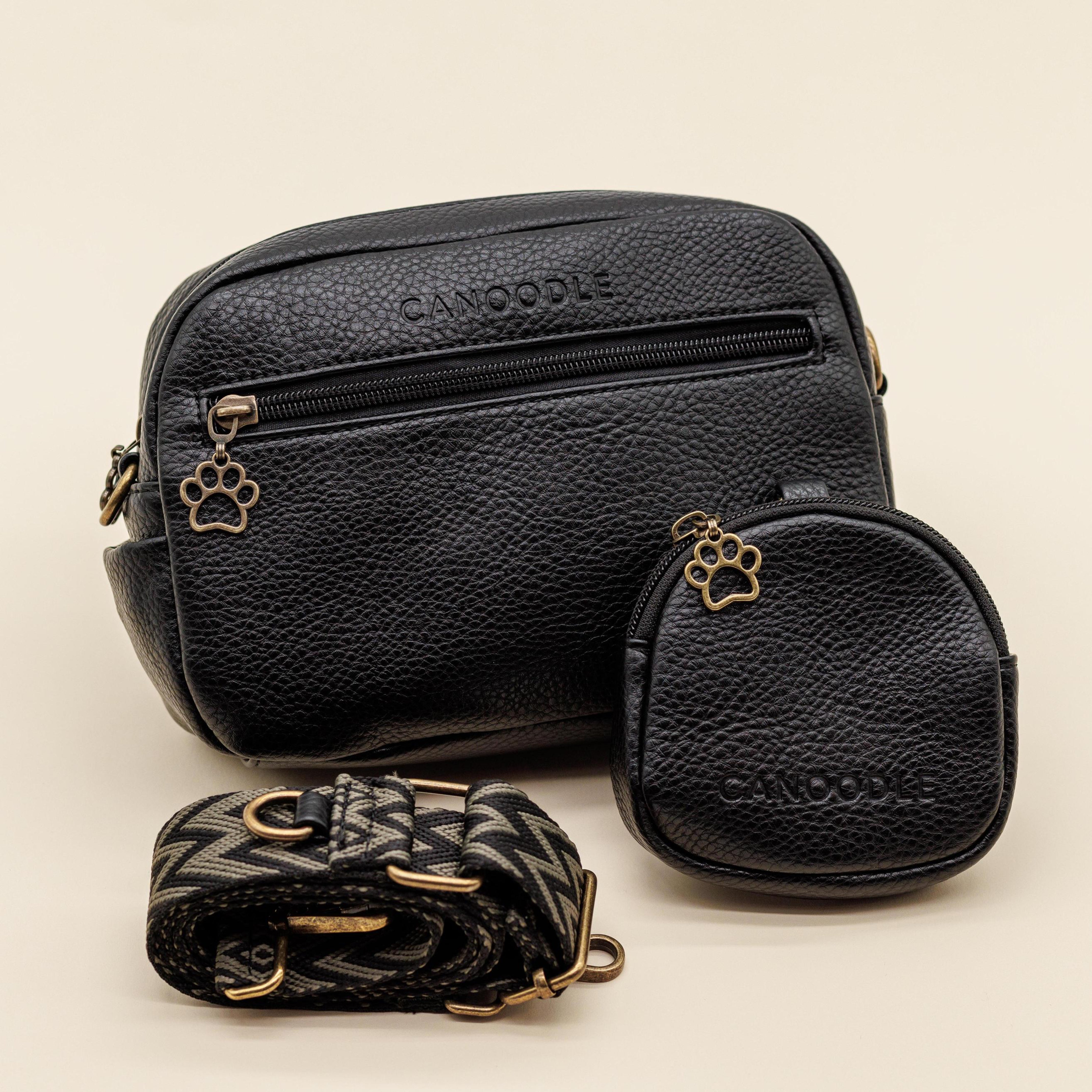 Black leather bags with paw print designs on a beige background