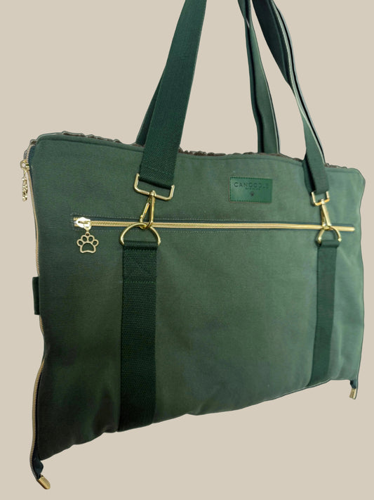 Green  Canvas Pet Travel bag with a gold zipper pocket for a laptop. Fold down sides to transform into a bed and car seat protector, includes  paw charms and grey fluffy inside. 