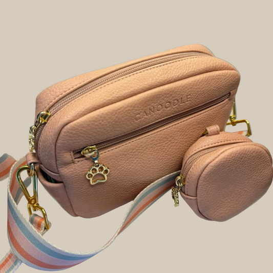 Pink handbag with a small round pouch and paw charm 