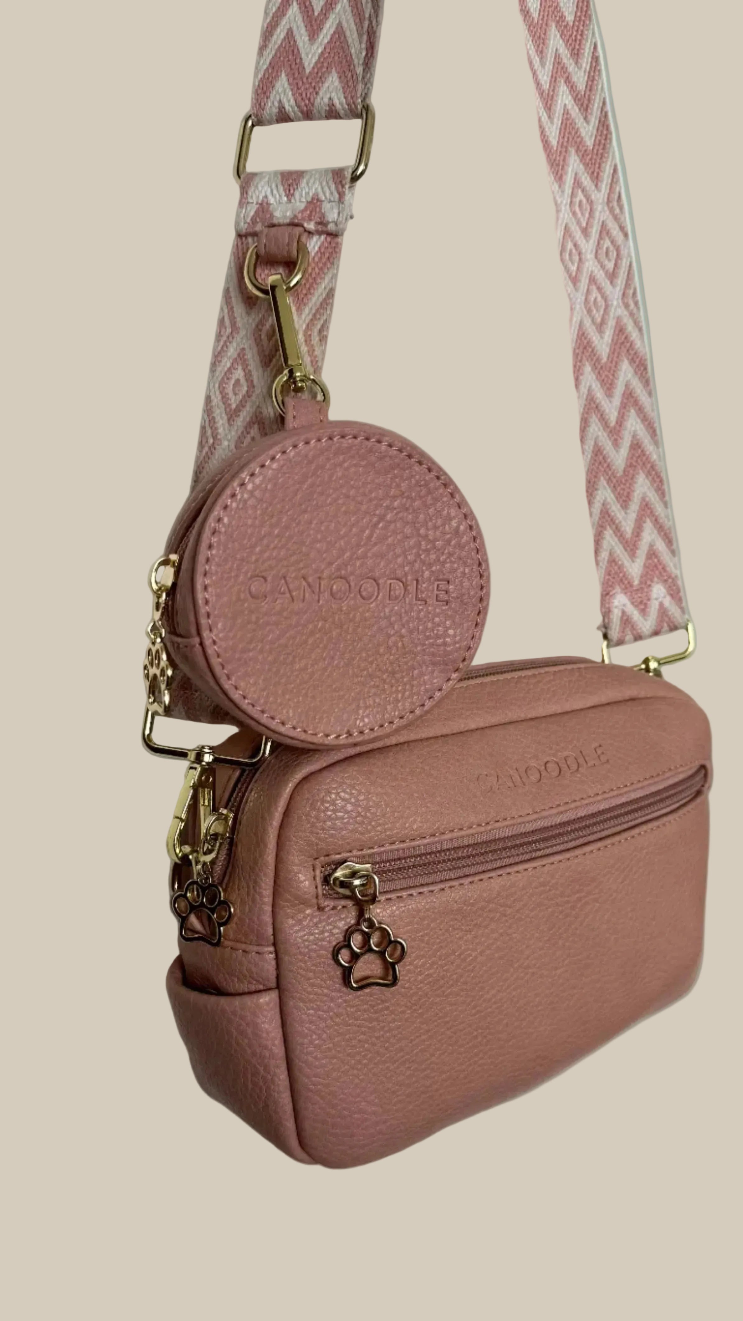 Pink handbag with a matching round pouch on a light gray background